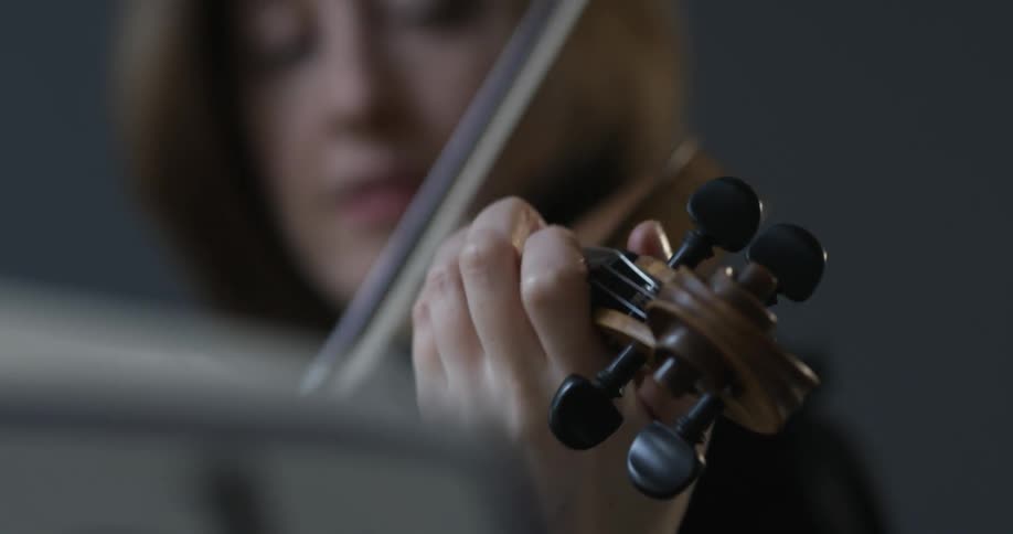 A woman plays a violin