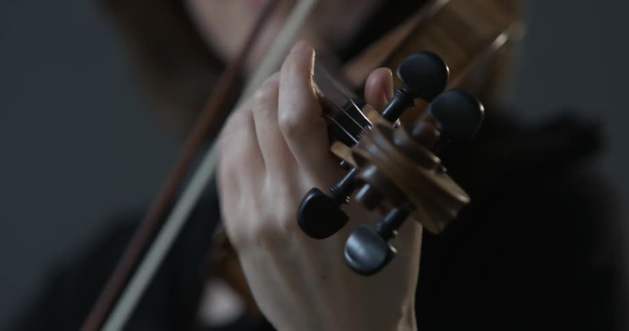 A woman is playing a violin