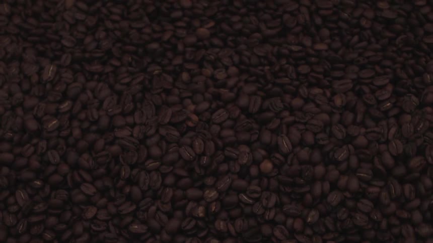 Coffee beans are swirled by a machine