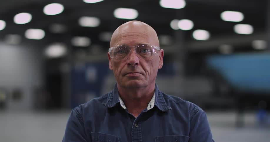 Man wearing safety glasses standing and smiling