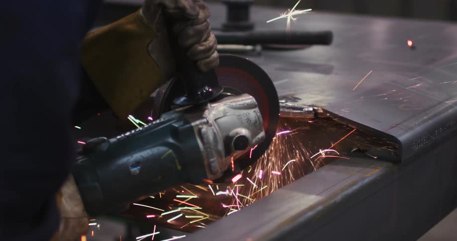 A man is using a circular saw to cut metal
