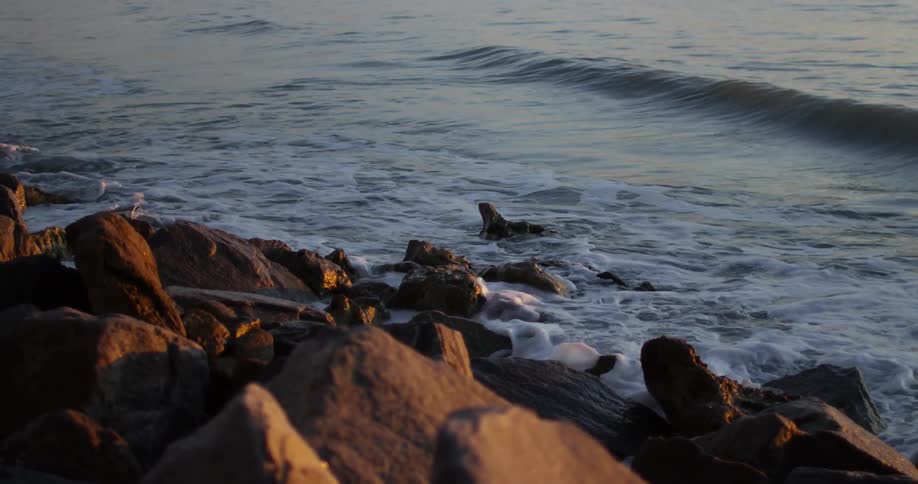 Ocean waves crash into rocks on the coast