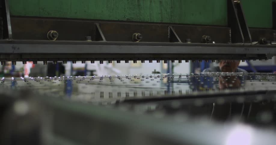 A person watches from the outside as a machine works