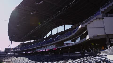 A sports stadium is shown on a sunny day