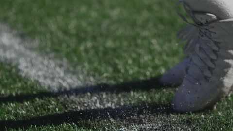 A person is running in place in some green grass