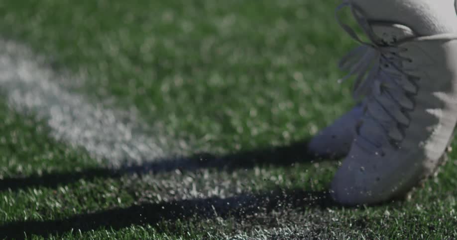 A person is running in place in some green grass