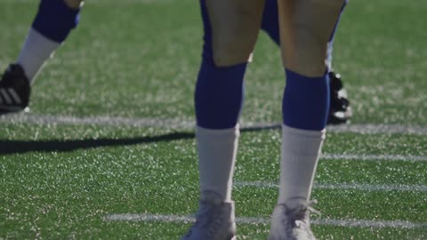 A player is stretching on a field
