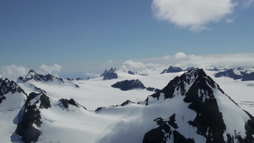 Mountain top peaks rise out of the snow