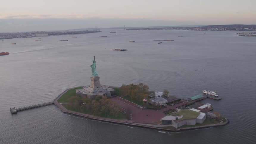 Aerial of the statue of liberty on the new york harbor at dusk
