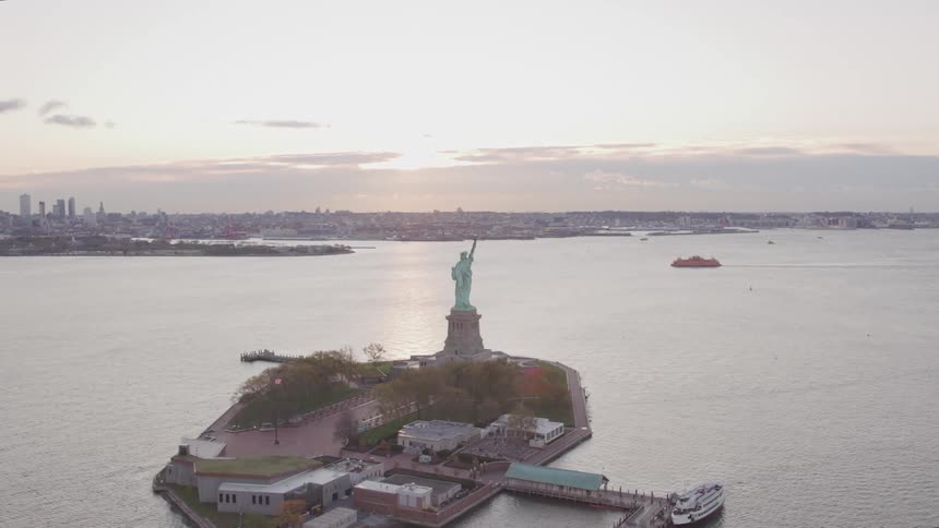 That statue of liberty sits on ellis island off the coast of new york city