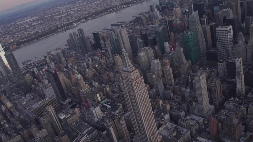 Aerial view of skyscrapers and tall buildings at dawn in the city