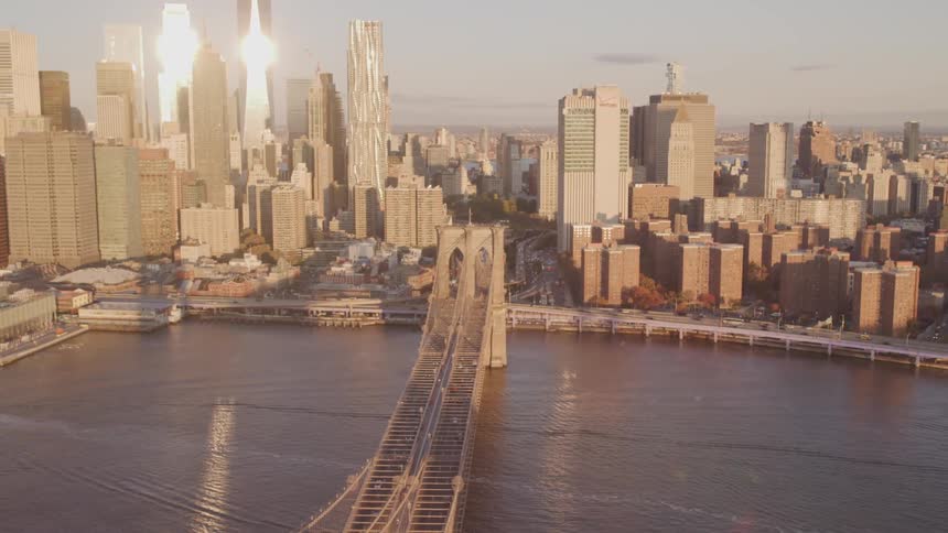 A bridge heading in to the city with the skyline behind it