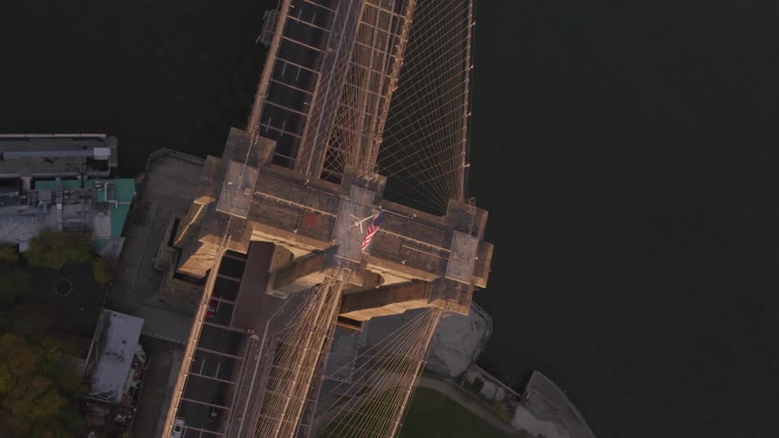View of brooklyn bridge tower and the american flag fluttering in the wind
