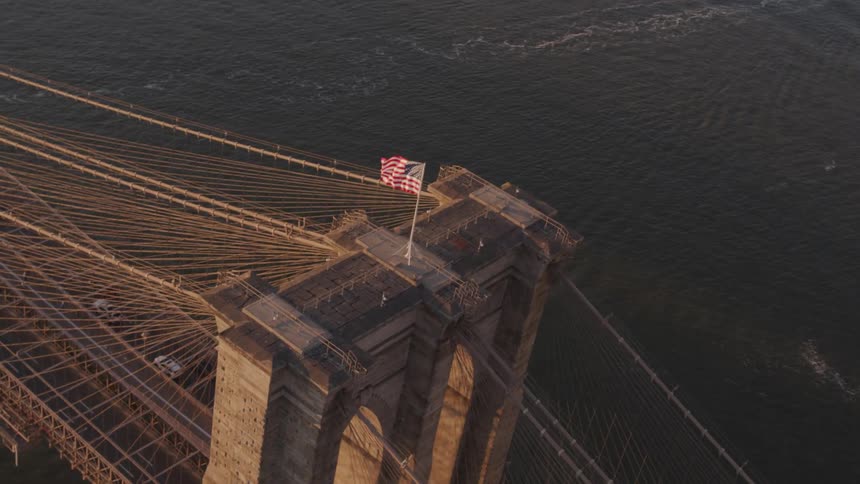 Cars crossing a bridge over the water heading in to a city