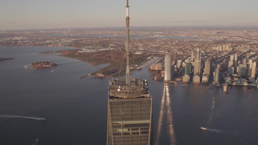 A city sprawls next to a large body of water