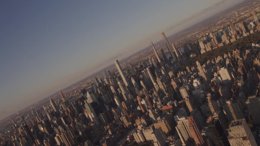 Buildings in a city sit under a blue sky