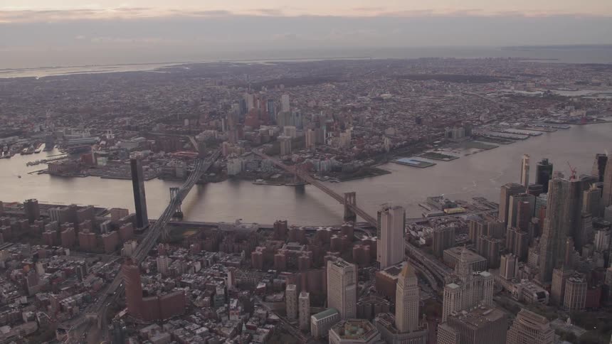 Aerial view of new york city with manhattan bridge and brooklyn bridge spanning the east river at dusk