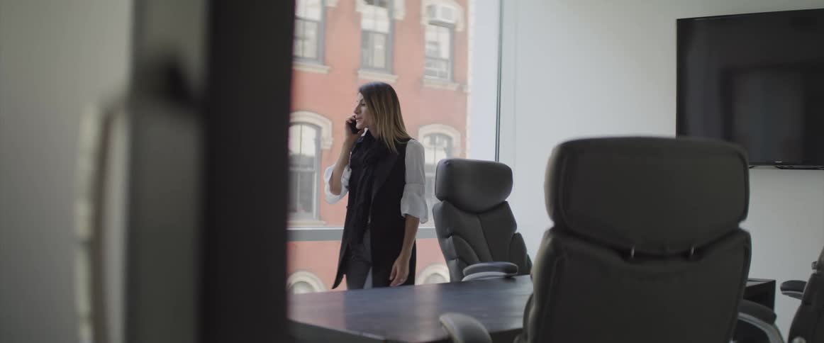 Businesswoman talks on the cell phone in the office