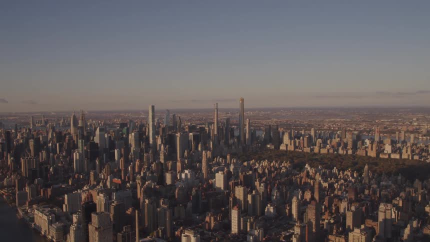 A large park sits in the middle of a large city filled with skyscrapers