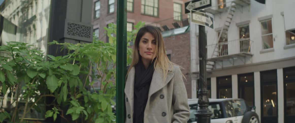 A woman stands on the street corner