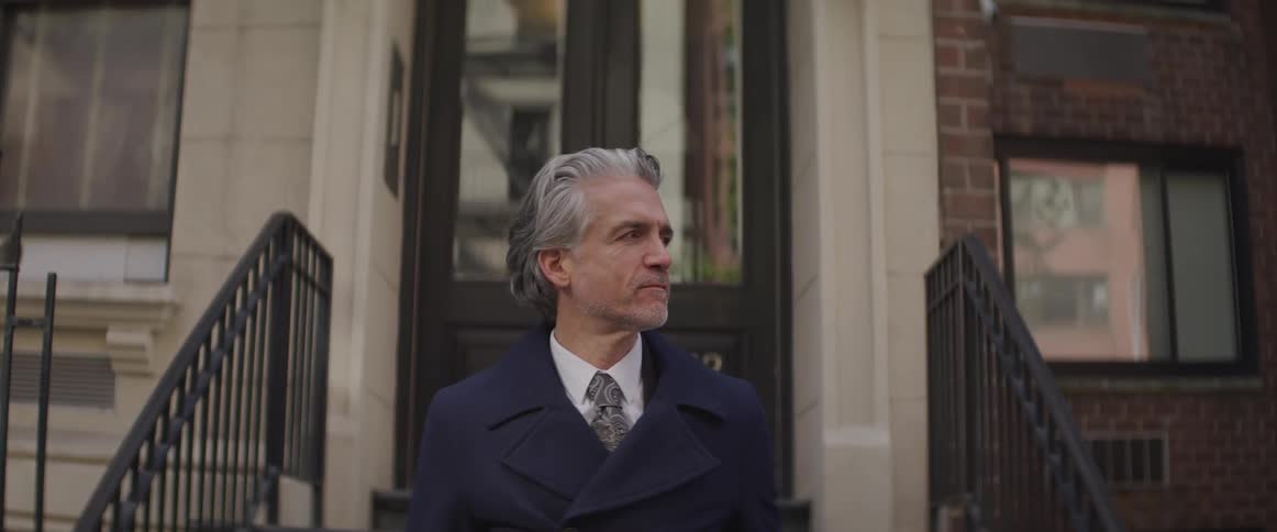 Businessman stands and looks around in the street