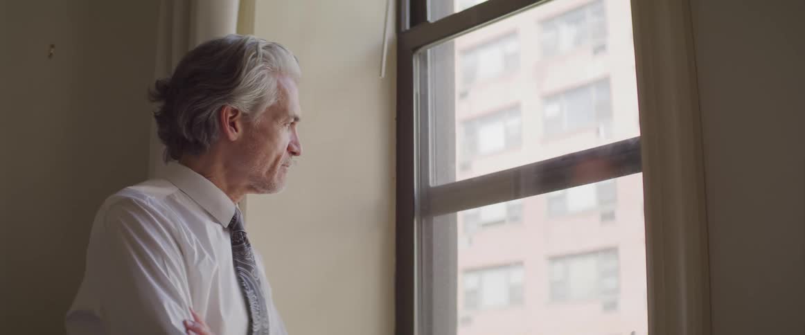 Side view of a businessman looking out the window