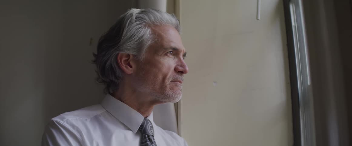 Senior businessman looks out the window