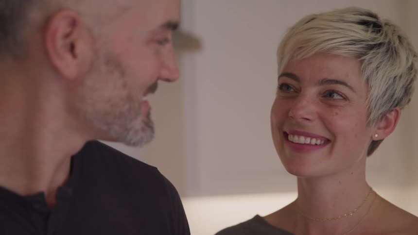 A man and woman look lovingly at one another