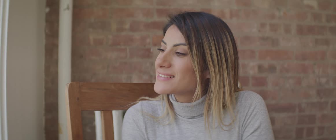 A woman sitting on a chair smiling