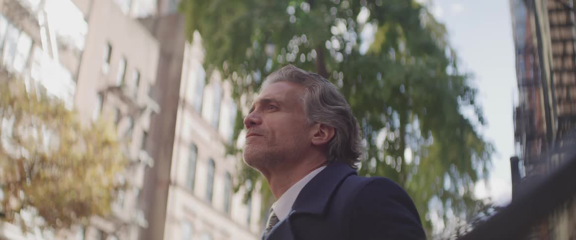 Businessman stands and looks ahead in the street
