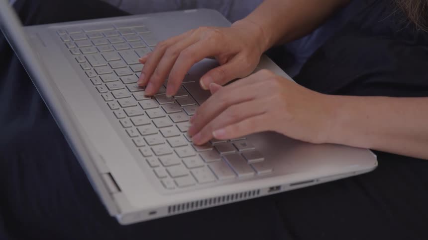 Close up of a hands typing on a laptop keyboard