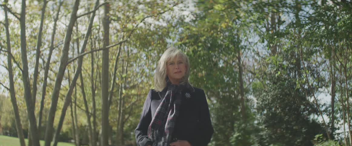 A woman stands in the park