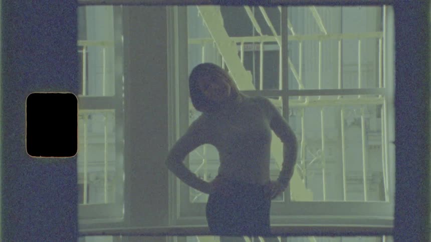 Woman leans to her left and right as she practices dance moves