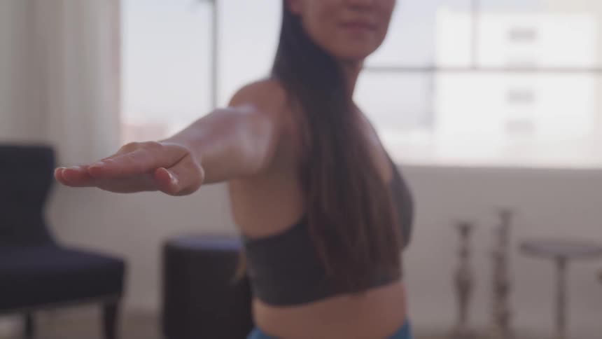 A woman doing yoga in an apartment during the day