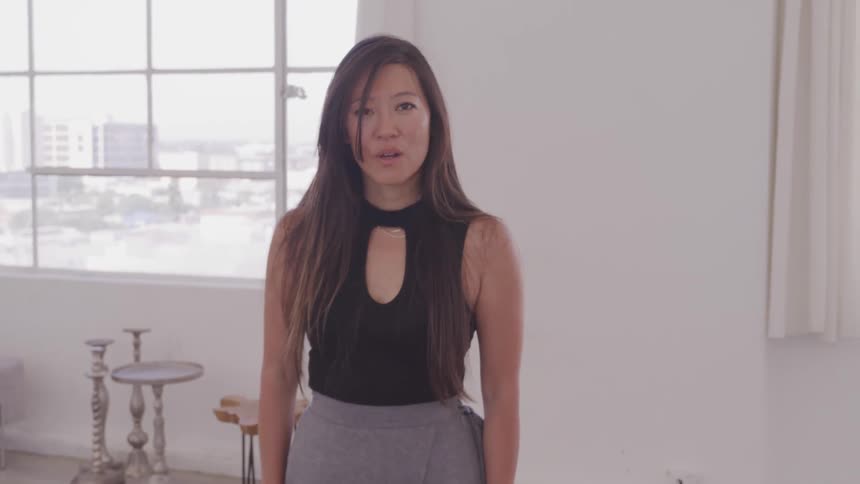 An asian walks forwards as she breathes heavily