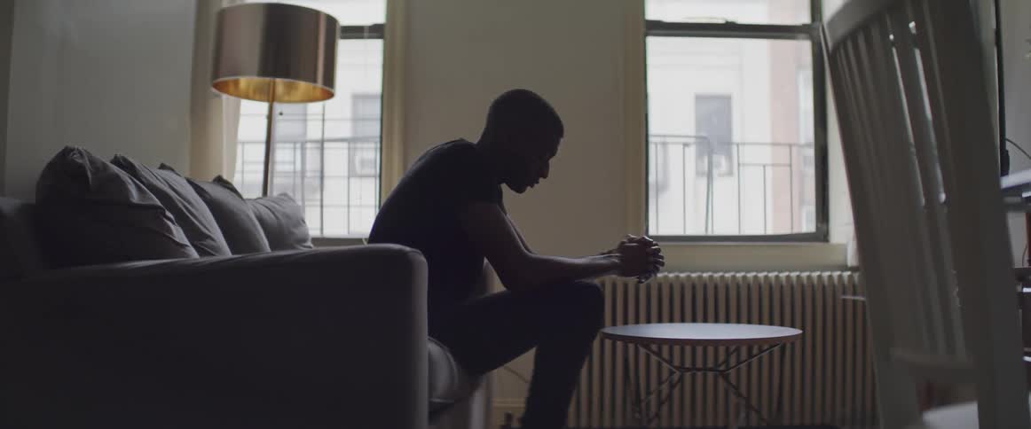 A man sits on the couch in the living room