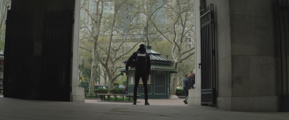 A man watches pedestrians walk by