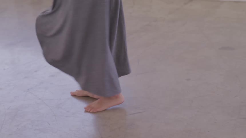 A woman twirls around in a circle