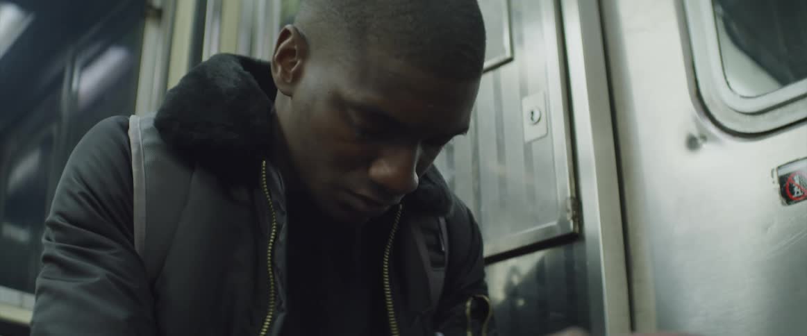 Young black man dozing while traveling on subway transit