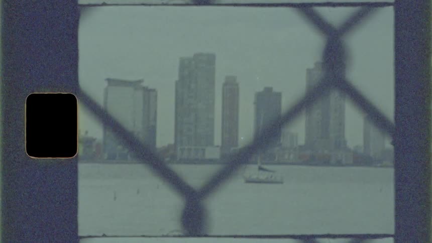 A boat on the water in front of a city skyline