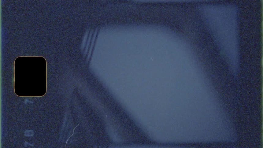 Beams of a truss bridge are viewed from below at night
