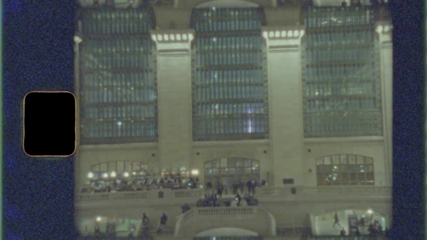 Crowds of people walk around inside a large building