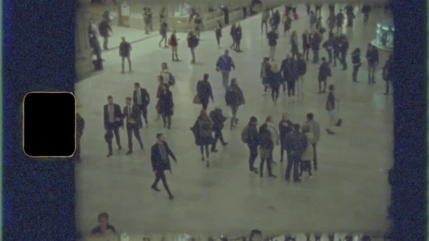 A crowd of people walking and standing around