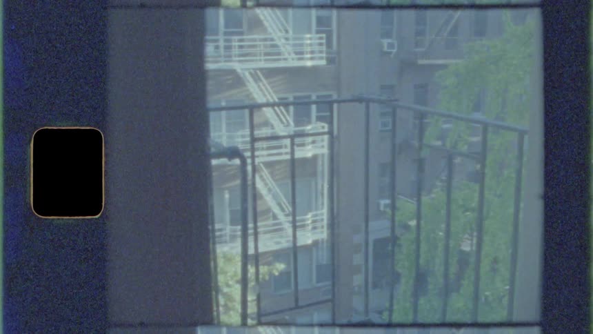 A balcony with trees and a building in the background