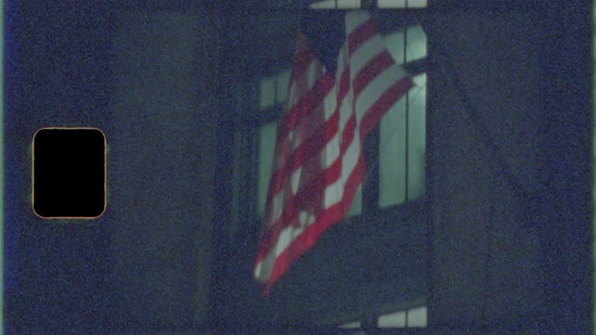 An american flag hanging on the outside of a building
