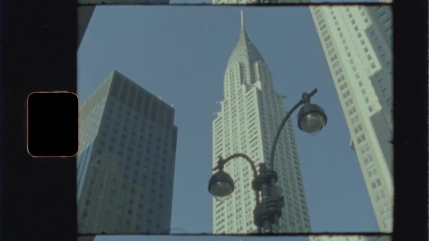 Skyscrapers of varying heights sit in front of a lamp post