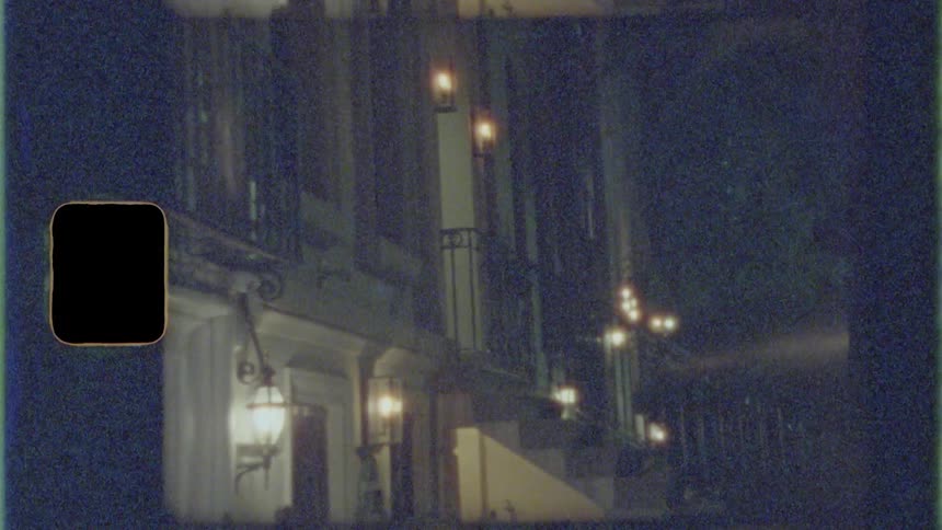 Apartment building at night with porch lights on