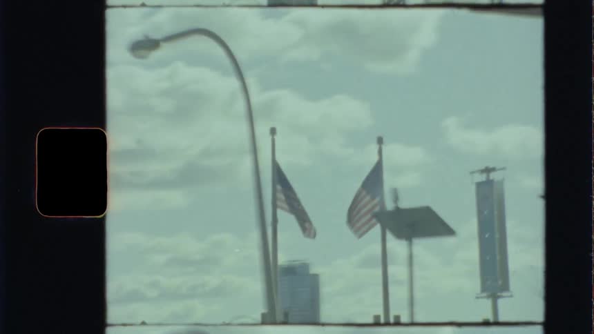 American flags on flagpoles in city caught on film