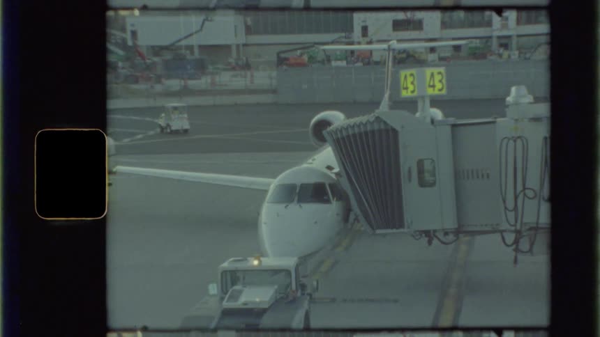 An airplane is connected to a jetway at an airport