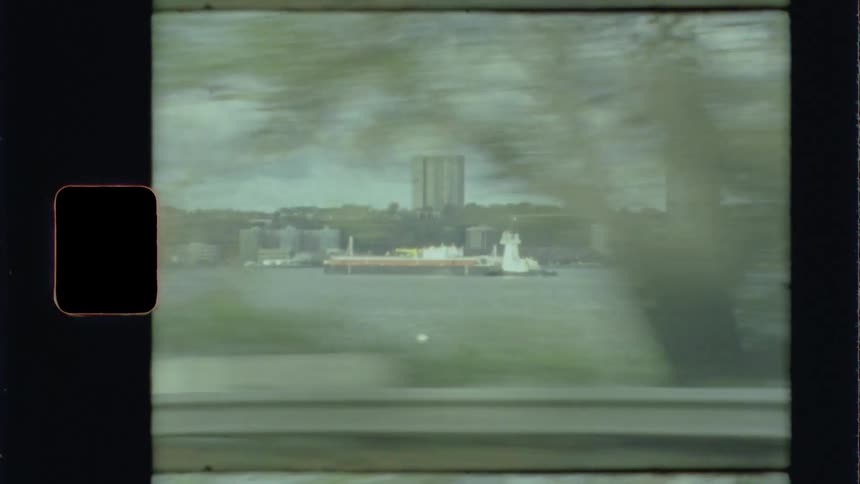 A river with a boat with buildings in the background